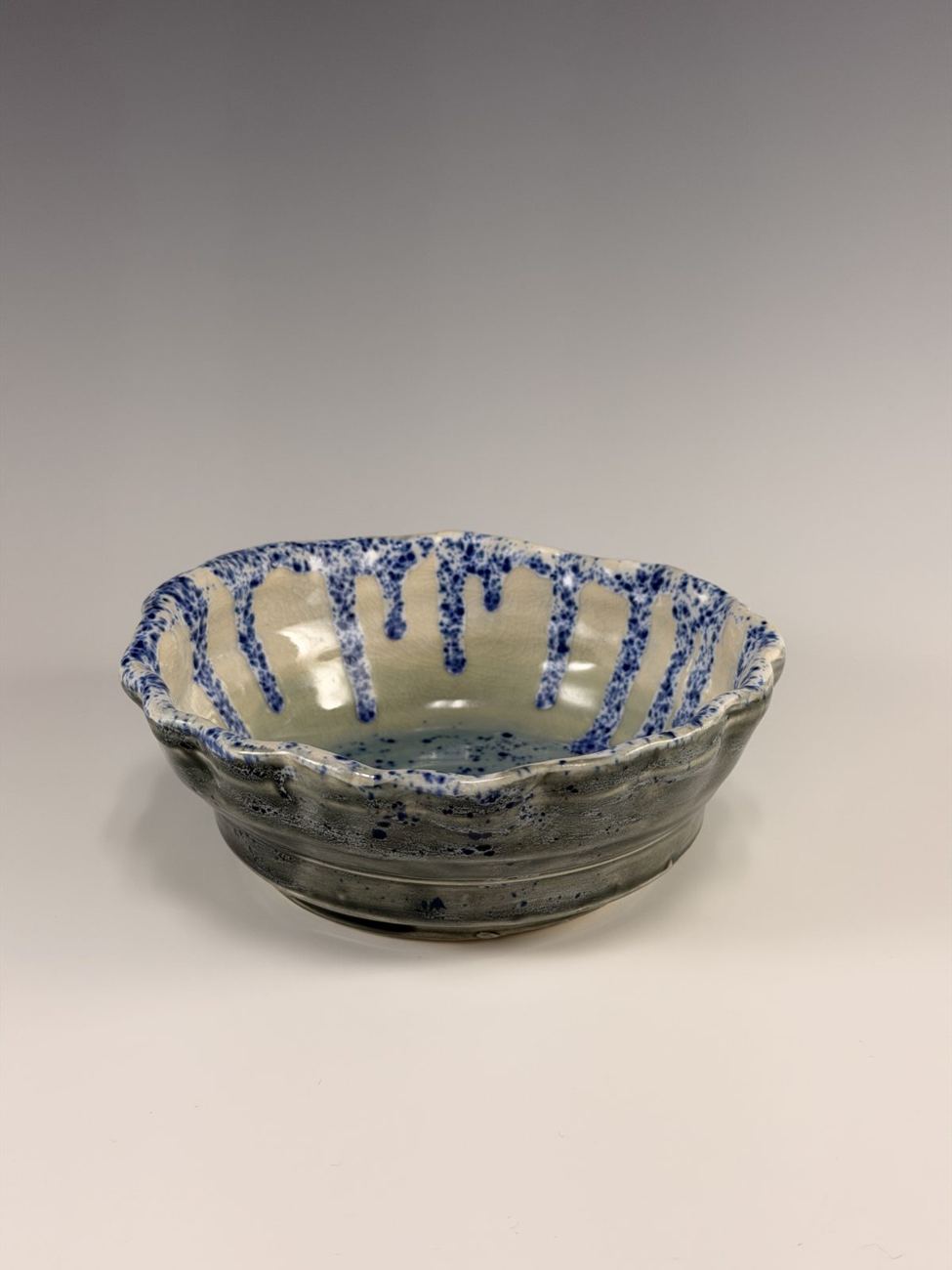 Scalloped bowl with a blue drip rim